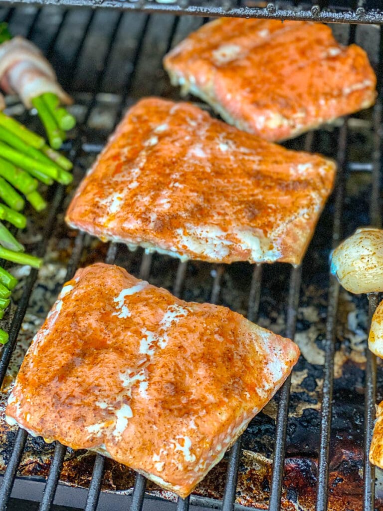 3 pieces of salmon lined up front to back on grill