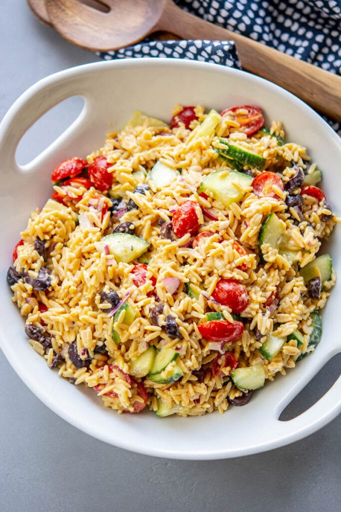 greek orzo salad in a white bowl