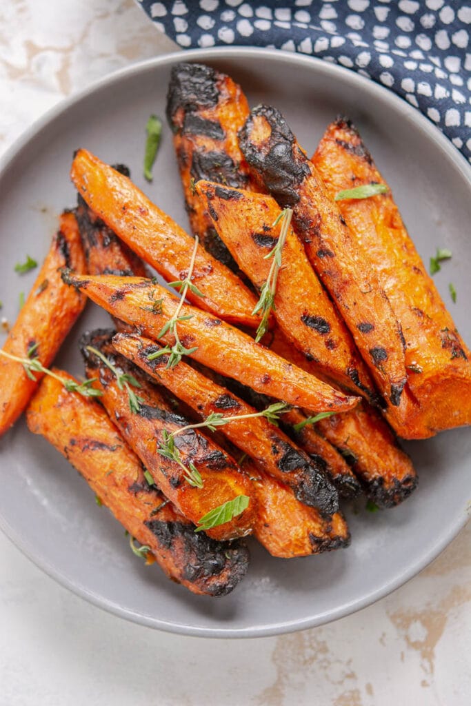 grilled carrots on a gray plate